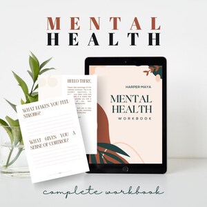 May include: A digital tablet displaying a mental health workbook with the title "Mental Health Workbook" by Harper Maya. The workbook has a peach background with abstract shapes in brown and green. The tablet is on a white surface with a plant in a glass vase and a printed page with the text "What makes you feel strong?" and "What gives you a sense of control?"