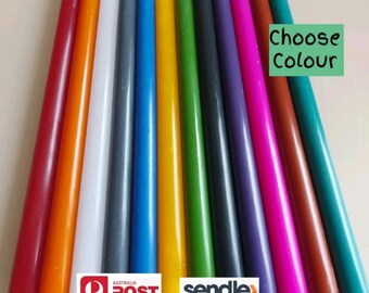 May include: Assortment of long, thin taper candles in various colors, including red, orange, white, gray, blue, yellow, green, purple, pink, brown, and teal. The text "Choose Colour" is written on a green background.