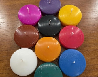 May include: A collection of ten round, flat tea light candles in various solid colors including purple, magenta, yellow, black, brown, red, orange, white, dark green, and blue. Each candle features a single centered white cotton wick.