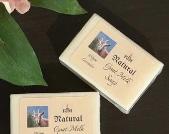 May include: Two bars of natural goat milk soap with lavender scent. Each bar has a label with a goat illustration and the text "Natural Goat Milk Soap". The soap is 100 grams.