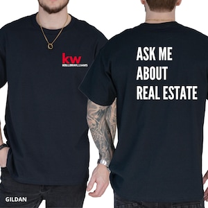 May include: A black t-shirt with the text "ASK ME ABOUT REAL ESTATE" on the back and the logo "kw KELLERWILLIAMS" on the front.