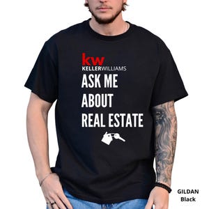May include: Black t-shirt with the Keller Williams logo in red and white. The text "ASK ME ABOUT REAL ESTATE" is printed below the logo, along with a graphic of a house and key.