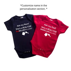 May include: Two baby onesies, one navy blue and one red. The navy onesie says "Ask my Mom! She's a REALTOR!" with the Keller Williams logo. The red onesie says "Ask my Dad! He's a REALTOR!" with the Keller Williams logo.