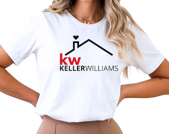 May include: A white short-sleeved t-shirt featuring a black graphic of a house roofline with a small heart above the chimney. Below the roofline, the red letters kw and the black text KELLERWILLIAMS are printed in a bold, sans-serif font.