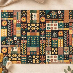 May include: A completed cross-stitch project featuring a geometric design with floral and abstract patterns in shades of teal, yellow, orange, and brown on a black background. The piece is framed by a white border and set against a neutral fabric.