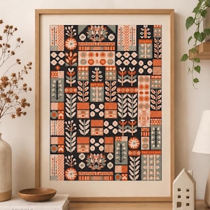 Op de afbeelding: Een ingelijst kunstwerk met een geometrisch patroon met bloem- en abstracte elementen in zwart, oranje, grijs en wit. Het kunstwerk wordt gepresenteerd in een houten lijst en is een decoratief stuk voor de interieurdecoratie. Het kunstwerk staat op een houten oppervlak.