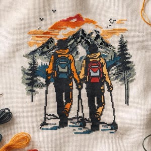 May include: Cross-stitch embroidery of two hikers holding hands, walking towards a mountain range. The hikers wear backpacks and use trekking poles. The sky is orange and yellow, and the mountains are blue and green. The embroidery is on a white fabric.