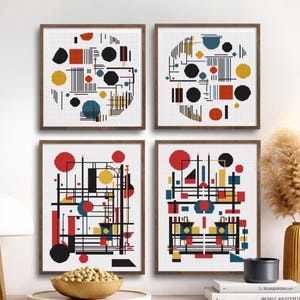 May include: Four framed abstract art prints. Each print features a geometric design with red, yellow, black, and blue shapes on a white background. The prints are in brown wooden frames, creating a cohesive set for wall decor.
