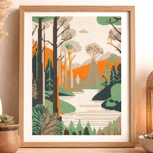Könnte beinhalten: Gerahmte Kreuzstich-Landschaft mit einer Waldszene mit Bäumen, einem Fluss und Bergen. Das Kunstwerk verwendet eine Farbpalette aus Grün, Orange und Braun. Der Rahmen ist aus Holz.