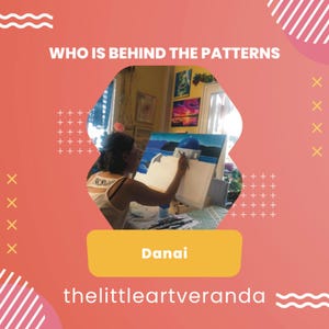 May include: A woman paints a seascape with a blue domed building on a canvas. The text "Danai" and "thelittleartveranda" are visible below the image.