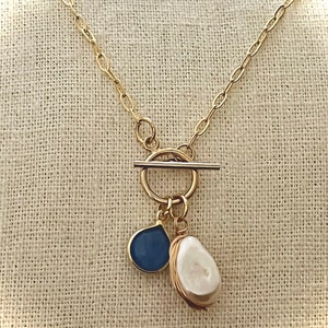 Gold Toggle Necklace. Gold Toggle Necklace Keshi Pearl and Blue Gem Toggle Necklace. Toggle Necklace with Pearl and Blue Gems.