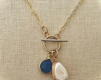 Gold Toggle Necklace. Gold Toggle Necklace Keshi Pearl and Blue Gem Toggle Necklace. Toggle Necklace with Pearl and Blue Gems.