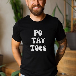 May include: A black t-shirt with white text that reads "PO TAY TOES".
