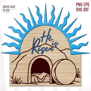 May include: A wooden sign with a blue sunburst behind it. The sign says "He is Risen" and depicts a tomb with a stone rolled away.