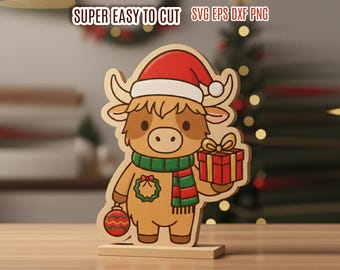 May include: Wooden Christmas decoration of a cartoon yak wearing a Santa hat, green and red scarf, and holding a gift. The yak also has a Christmas ornament and a wreath. The text "SUPER EASY TO CUT" is at the top.