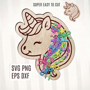 May include: Wooden unicorn-shaped craft with colorful bows and stars. The text "SUPER EASY TO CUT" and "SVG PNG EPS DXF" are also visible. A smaller unicorn head is also included.
