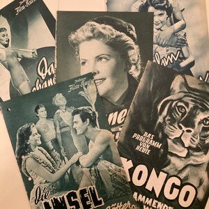 May include: A collection of vintage movie posters featuring black and white images. The posters are for the films "Die Insel der zornigen Götter" and "Tongo - Ammende Wildnis".