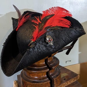 The Fire Heart Tricorne -  Authentic Pirate Style, Black Ostrich Feather set with Fyre Eyed Skull.  Durable, weatherproof, for Sea Thieves