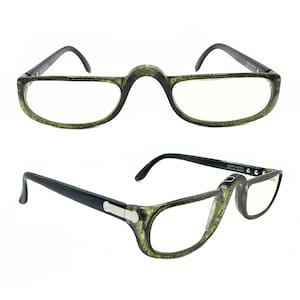 May include: Eyeglasses with a distinctive design. The frames are a mottled green, with black arms and a bridge that curves over the nose. The lenses are clear, and the glasses appear to be in good condition.