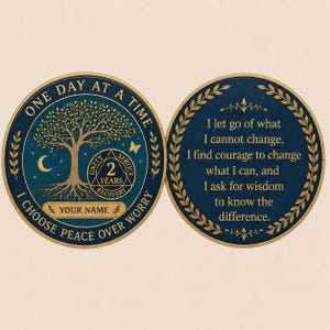May include: Two-sided coin with a navy blue and gold design. One side features a tree, moon, and butterfly with the text "ONE DAY AT A TIME" and "I CHOOSE PEACE OVER WORRY". The other side has a quote about change.