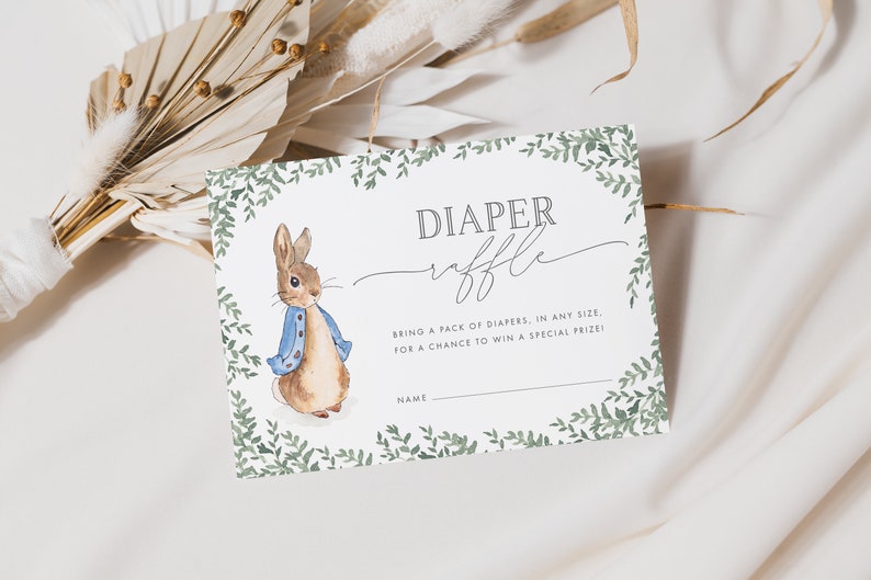 5x3.5 Peter Rabbit Baby Shower Diaper Raffle Ticket, with a green leafy border, and grey text. You can personalise your editable templates in Corjl.