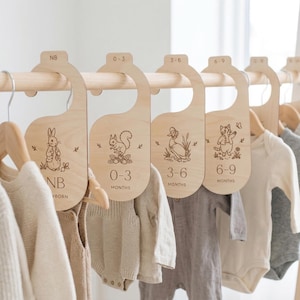 May include: A set of three ceramic mugs with a speckled, matte finish in cream, light grey, and dark grey. Each mug has a simple, minimalist design and a rounded handle.