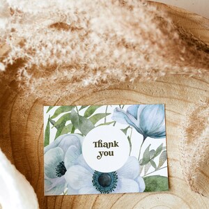 An elegant blue floral 5x3.5 Landscape Baby Shower Thank You Card. Thank You text is in brown. You can personalise your editable Thank You Card template in Corjl.