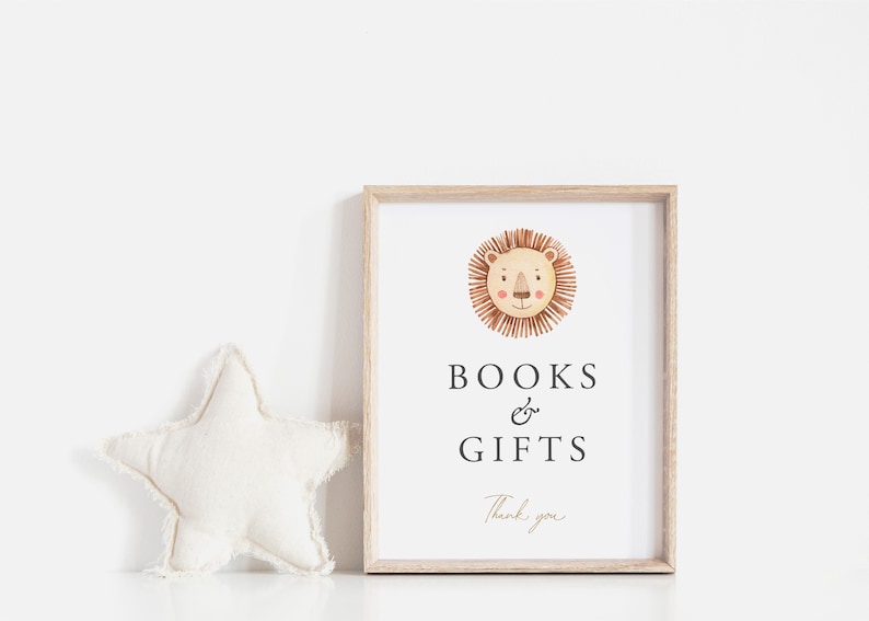 A minimalist 8x10 Portrait Baby Shower Books and Gifts Baby Sign, with a watercolour boho lion face. The editable elegant dark grey and gold text is personalisable in Corjl.