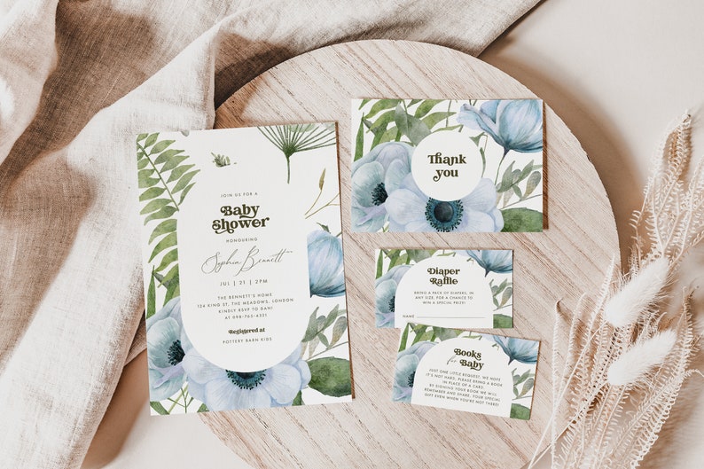 An elegant blue floral Baby Shower template set with a 5x7 Invitation, 5x3.5 Thank You Card, Books for Baby Card, and Diaper Raffle Ticket. The text is in brown. Editable in Corjl.