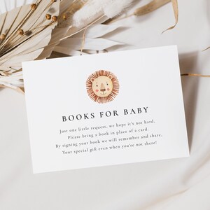 A minimalist 5x3.5 Baby Shower Books for Baby Card, with a watercolour boho lion face. The editable elegant dark grey text is personalisable in Corjl.