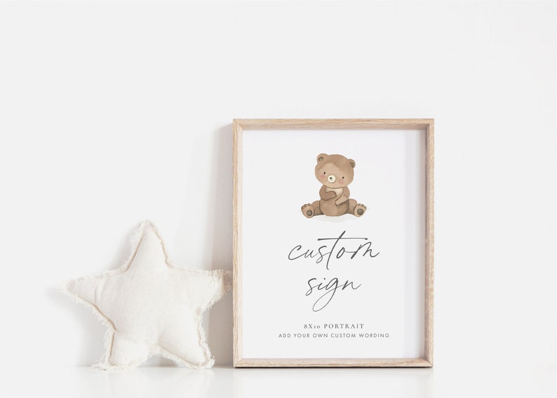 A modern 8x10 Custom Sign for Baby Showers and Birthday Parties, with the sweetest little brown teddy bear holding a flag and marching. The editable elegant dark grey text is personalisable in Corjl.