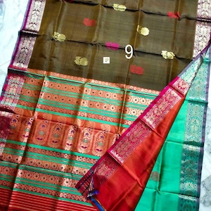May include: A brown silk saree featuring gold and red floral motifs across the main body. The wide border displays horizontal stripes in green, orange, and red with intricate gold zari patterns. The number 9 is printed in white on the fabric.