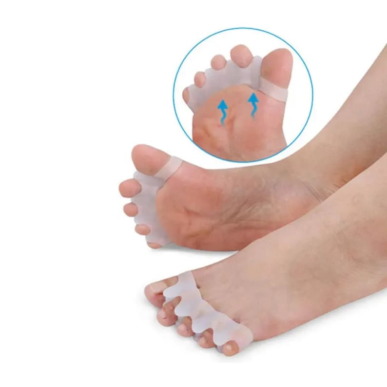 May include: White silicone toe separators designed to help align toes and reduce bunions. The separators are shown on a person's foot.