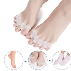 May include: White silicone toe separators for correcting bunions and hammertoes. The separators are shown on a person's feet and in a close-up view. The image also shows white ankle socks.