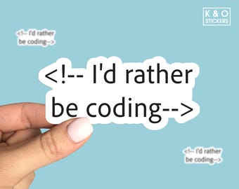 May include: White sticker with black text that reads "<!--- I'd rather be coding--->". The sticker is being held by a hand.