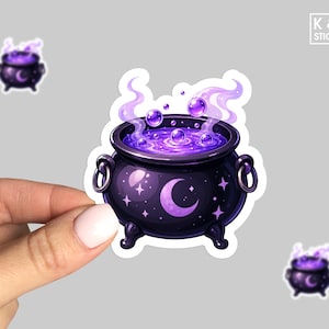May include: A die-cut sticker featuring a black cauldron with a purple crescent moon and star pattern. The cauldron contains a bubbling, glowing purple liquid with swirling light purple steam rising from the top. The design has a white border.