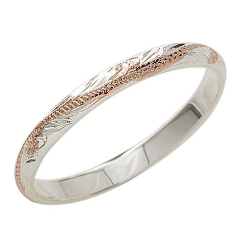 May include: A thin silver band with a rose gold inlay and an engraved floral design.