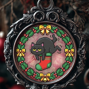 May include: A decorative Christmas ornament with a black cat cross-stitch design. The cat is lying in a Christmas stocking. The ornament is framed in a silver filigree design and surrounded by a wreath of holly and bows.