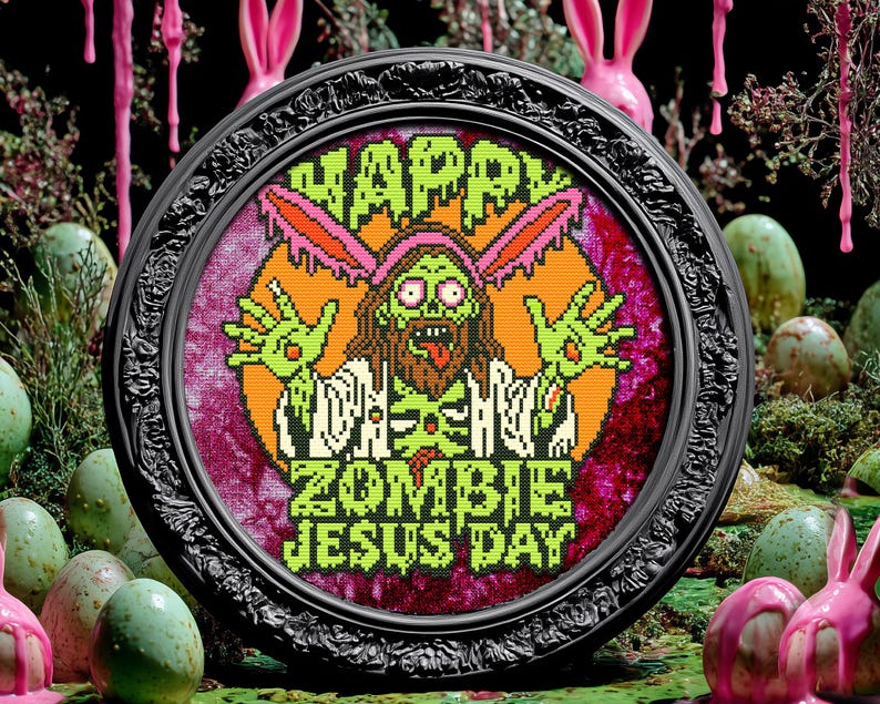 May include: A framed cross-stitch design featuring a zombie Jesus wearing a pink bunny ear headband. The text reads "Happy Zombie Jesus Day".