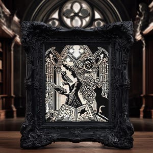 May include: Black framed cross-stitch art featuring a witch with an owl, cat, and spell book. The artwork is in black and cream colors, set against a gothic library backdrop. The frame has ornate detailing.