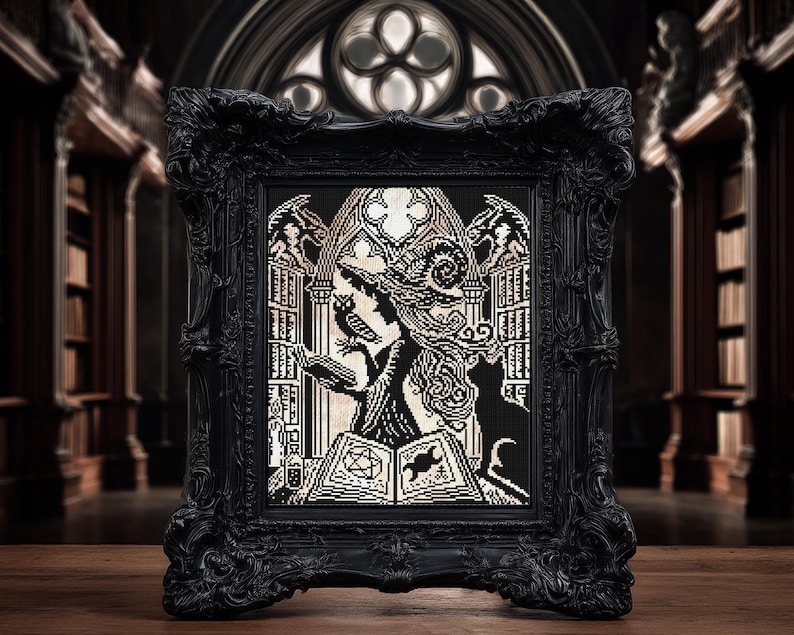 May include: Black framed cross-stitch art featuring a witch with an owl, cat, and spell book. The artwork is in black and cream colors, set against a gothic library backdrop. The frame has ornate detailing.