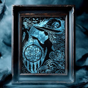 May include: Framed cross-stitch art featuring a witch silhouette holding a dreamcatcher. The artwork is in shades of black and teal, with a detailed design. The frame is dark brown. Feathers are in the background.