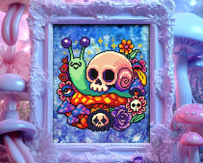 Puede incluir: Un punto de cruz enmarcado con un dise&ntilde;o caprichoso de una calavera, un caracol y setas. La calavera es rosa, el caracol es verde y las setas son de varios colores. El fondo es azul y el marco es blanco.