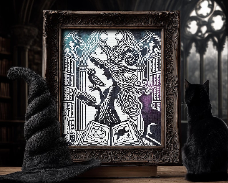 May include: A framed black and white cross-stitch artwork depicting a witch with an owl, a black cat, and an open book with occult symbols. A black witch's hat and a black cat are in the foreground. The artwork is in a dark, ornate frame.