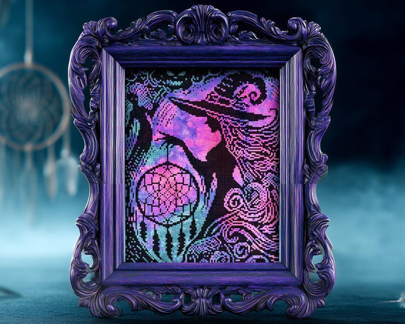 May include: A framed cross-stitch artwork featuring a witch silhouette with a dreamcatcher. The artwork uses a pixelated style with vibrant colors including pink, purple, and teal. The frame is a dark purple with ornate detailing.