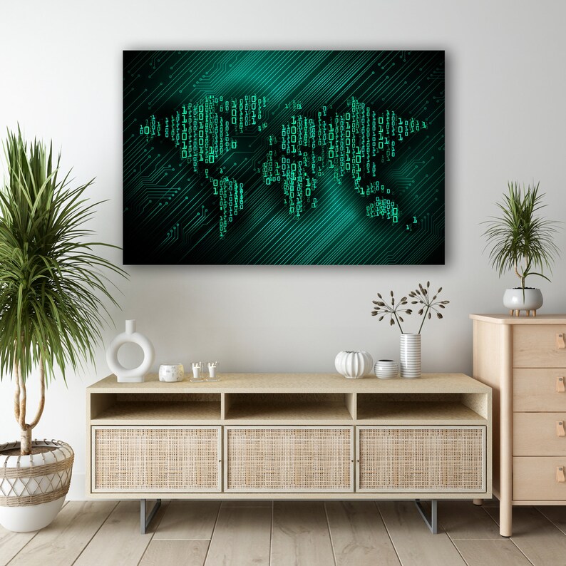 May include: A digital art print of a world map made of circuit boards and binary code. The map is in shades of green and black on a dark background. The print is hanging on a white wall above a light wood cabinet with wicker doors.