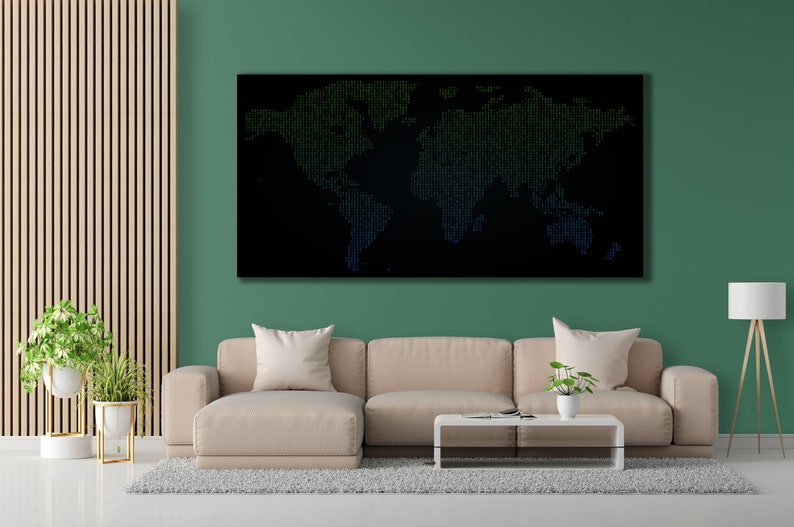 May include: A black and green world map made of small dots, hanging on a green wall in a living room setting. A beige sofa with a white coffee table and a floor lamp are in the foreground.