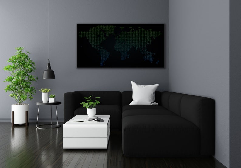 May include: A black sectional sofa with a white cushion sits in a living room with a white coffee table and a black pendant light hanging from the ceiling. A world map made of green and blue dots is hanging on the wall above the sofa.