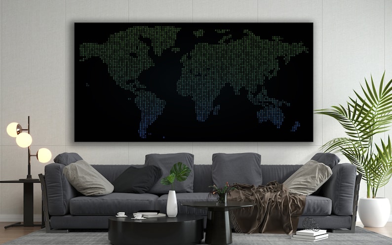 May include: A black and white world map made of green and blue pixels hangs above a grey sofa in a modern living room. The sofa has a throw blanket and a plant on the coffee table.