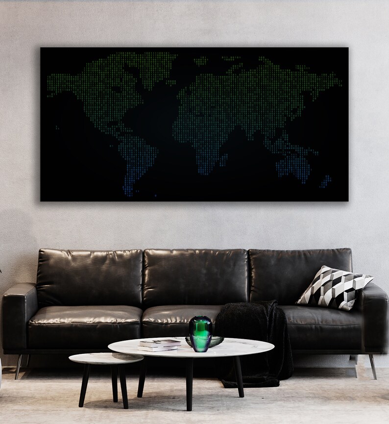 May include: A black and white world map made of green and blue dots on a black background. The map is hanging on a wall above a black leather sofa with a throw blanket and a decorative pillow. There is a green glass vase on a white marble coffee table.